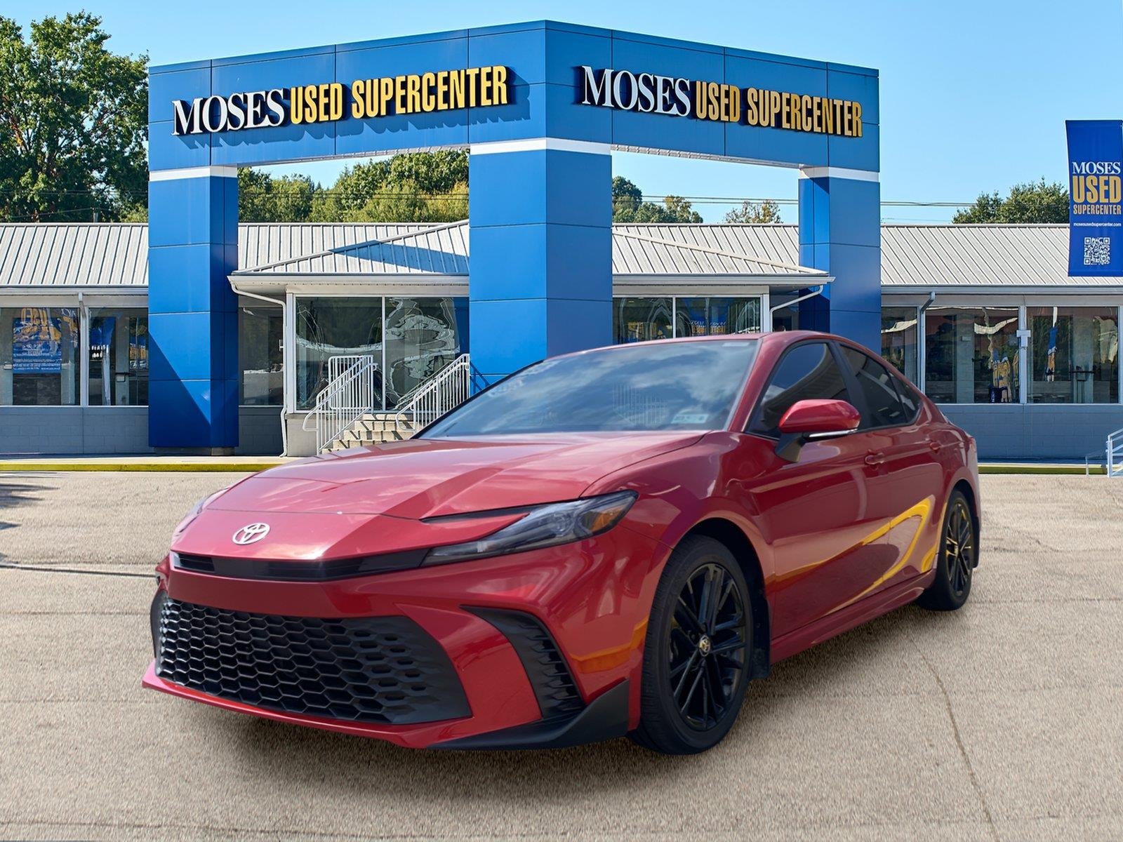 2025 Toyota Camry SE in Supersonic Red — front three-quarter view